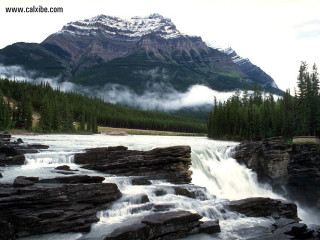 Waterfall mountain clouds trees sky - a waterfall free wallpaper