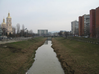 River lush field tall buildings - a lush green field next free wallpaper