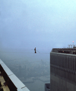 Man tightrope walking city skyline - the foggy day free wallpaper