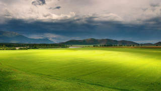 Green grass field mountains clouds - a large field free wallpaper for desktop