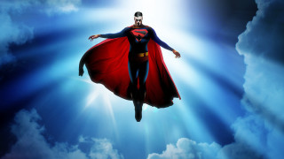 Superman flying heroic pose cape - his hands out in the air free wallpaper for desktop