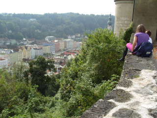 Woman child sitting ledge overlooking - a view of a town free wallpaper