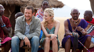 Group people bench hut thatched - a group of people sitting next free wallpaper