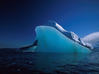Iceberg floating ocean sky clouds - an iceberg free wallpaper