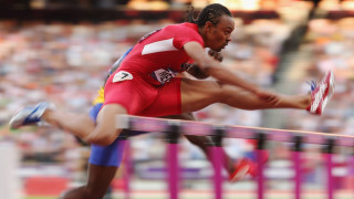 Man running hurdle stadium crowd - a crowd free wallpaper