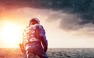 Man space suit boat ocean - the sun shining behind free wallpaper