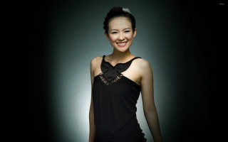 Woman black dress smiling camera 4 - a black background behind her free wallpaper