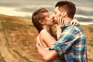 Man woman kissing field cloudy - romantic free wallpaper for desktop