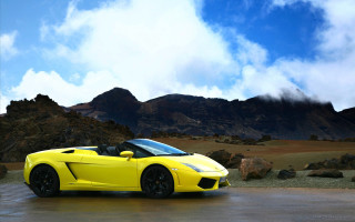 Yellow sports car mountain range - a mountain range in the background free wallpaper