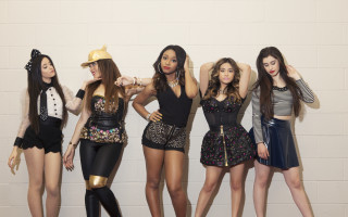 Women group brick wall standing - a brick wall behind them free wallpaper