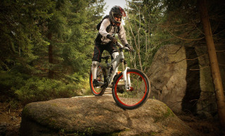Man riding bike rock woods 2 - top of a rock free wallpaper