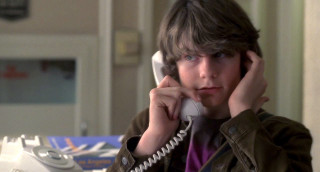 Young boy phone serious look - a cord free wallpaper