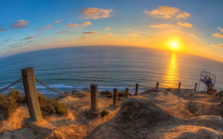 Sunset ocean lifeguard tower rope - a sunset over the ocean free wallpaper