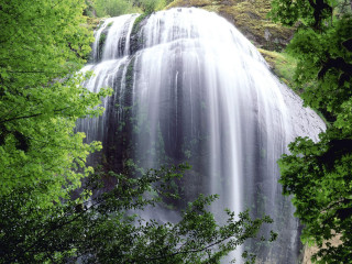 Waterfall surrounding trees nature forest - a large amount of water free wallpaper