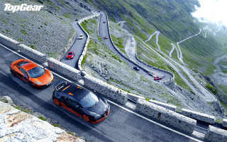 Orange sports cars winding road - steep free wallpaper