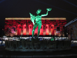 Statue man bird building red - a statue of a man holding free wallpaper