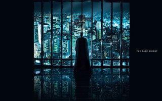 Man standing window cityscape nighttime - a batman symbol free wallpaper