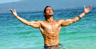 Man standing ocean arms outstretched 2 - muscular free wallpaper