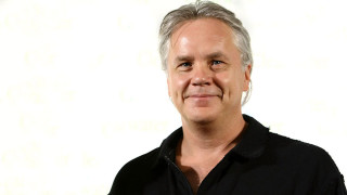 Man grey hair black shirt 2 - a white wall behind free wallpaper