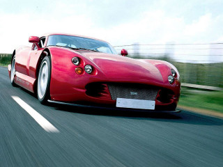 Red sports car driving road 11 - a field of grass and trees free wallpaper