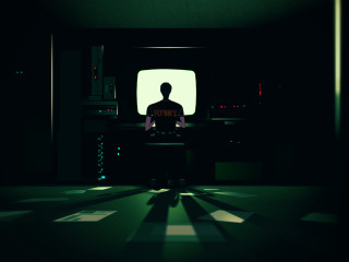 Man sitting dark room tv - screen free wallpaper