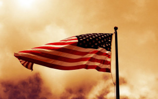 Flag flying wind cloudy sky - a sunbeam in the background free wallpaper