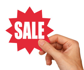 Hand holding red sale sticker - a hand holding free wallpaper