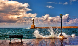 Lighthouse brickwalkway bench water sunset - a light house in the distance free wallpaper