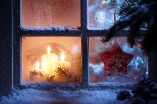Candle lit window snow christmas - a christmas tree in the background free wallpaper