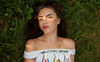 Woman laying on grass blowing - dorothy coke free wallpaper