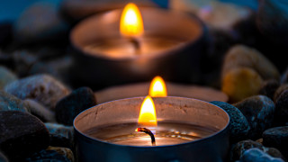 Lit candle rocks blue background - bracha l. ettinger free wallpaper