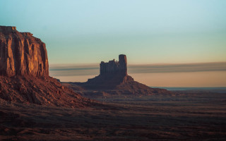 Desert rock formation sky clouds - a large rock formation in the middle of a desert area free wallpaper