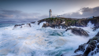 Lighthouse rocky cliff waves stormy - a lighthouse in the distance free wallpaper