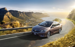 Mountain ocean road car sunset - a road near a mountain range free wallpaper