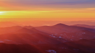 Mountain range sunset plane view 2 - volumetric light free wallpaper for desktop