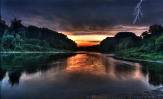 River lightning dark sky clouds - a lightning bolt in the sky above free wallpaper