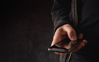Person holding cellphone pointing dark - both hand free wallpaper