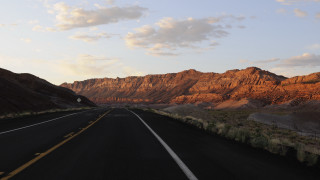 Mountain road sunset clouds horizon - a yellow line free wallpaper