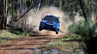 Blue car jumping dirt road - a blue car free wallpaper for desktop