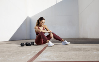 Woman sitting crossed legs dumbbells - a pair free wallpaper for desktop