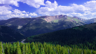 Mountain range road trees clouds - a mountain range free wallpaper