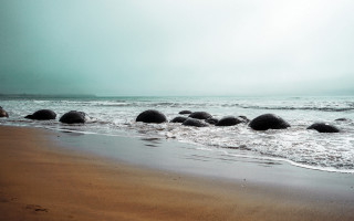 Beach rocks sand ocean cloudy - a sandy beach next free wallpaper