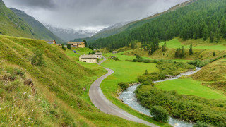 Winding road valley house stream - free landscape wallpaper
