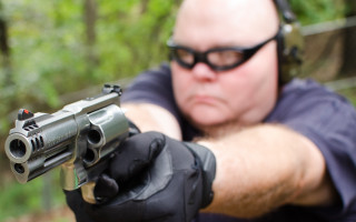 Male aiming gun gloves glasses - round free wallpaper for desktop