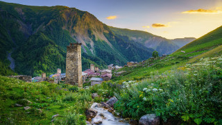Lush hillside stream tower cloudscape - a lush green hillside free wallpaper