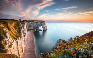 Cliff beach water sunset arch - a large body of water free wallpaper
