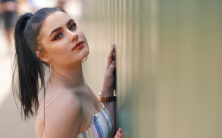 Woman leaning wall pony tail - a woman leaning against a wall free wallpaper