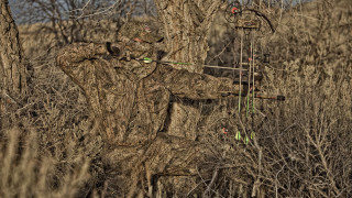 Camouflage man bow arrow wooded - symmetry accurate features free wallpaper