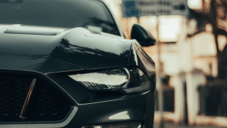 Car front bumper headlights city - a building in the background free wallpaper for desktop