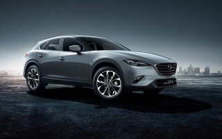 Silver mazda city skyline night - a foggy sky free wallpaper